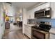 Kitchen with stainless steel appliances that opens to the dining room and living room at 750 E Northern Ave # 2143, Phoenix, AZ 85020