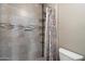 The bathroom's shower is tiled with neutral colors and is equipped with plenty of storage for toiletries at 750 E Northern Ave # 2143, Phoenix, AZ 85020