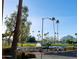 Scenic community view featuring lush green spaces, palm trees, and a distant mountain backdrop at 7970 E Camelback Rd # 209, Scottsdale, AZ 85251