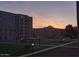 Apartment complex with manicured grounds and scenic views at sunset at 7970 E Camelback Rd # 209, Scottsdale, AZ 85251