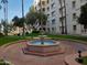 Outdoor circular fountain in a well-maintained community area with trees and landscaping at 7970 E Camelback Rd # 209, Scottsdale, AZ 85251