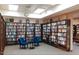 Community library with extensive bookshelves and cozy seating area for reading at 7970 E Camelback Rd # 209, Scottsdale, AZ 85251