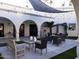Cozy community patio area with seating, pavers, decorative lighting, and lush greenery at 7970 E Camelback Rd # 209, Scottsdale, AZ 85251