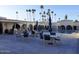 Community pool area with covered kitchen and lounge chairs surrounded by palm trees at 7970 E Camelback Rd # 209, Scottsdale, AZ 85251
