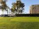 Manicured putting green and landscaping, with the condominium buildings in the background at 7970 E Camelback Rd # 209, Scottsdale, AZ 85251