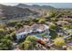 Aerial view of a sprawling estate showcasing a pool, lush landscaping, and mountain views at 8229 N Ridgeview Dr, Paradise Valley, AZ 85253