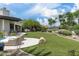 Expansive backyard with manicured lawn, outdoor seating, and lush landscaping at 8229 N Ridgeview Dr, Paradise Valley, AZ 85253
