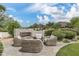 Inviting backyard seating area featuring comfortable furniture, an outdoor fireplace, and mature landscaping at 8229 N Ridgeview Dr, Paradise Valley, AZ 85253