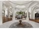 Grand foyer featuring decorative columns, a round wood table, and views of the formal living room at 8229 N Ridgeview Dr, Paradise Valley, AZ 85253