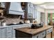 Stylish kitchen features gray cabinetry, brick accents, open shelving, and views of the outdoor area at 8229 N Ridgeview Dr, Paradise Valley, AZ 85253
