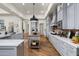 Open concept kitchen with gray cabinets, a large center island, and hardwood flooring throughout at 8229 N Ridgeview Dr, Paradise Valley, AZ 85253