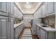 Well-organized laundry room with custom cabinets, quartz counters, and modern appliances at 8229 N Ridgeview Dr, Paradise Valley, AZ 85253