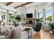 Bright living room featuring a brick fireplace, wood beams, and plush seating at 8229 N Ridgeview Dr, Paradise Valley, AZ 85253