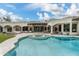 Beautiful backyard featuring a large sparkling pool with integrated spa and lush landscaping at 8229 N Ridgeview Dr, Paradise Valley, AZ 85253