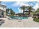 Gorgeous backyard featuring a pool, spa, lush landscaping, and palm trees at 8229 N Ridgeview Dr, Paradise Valley, AZ 85253