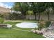 Backyard putting green featuring a sand trap, artificial turf, and mature landscaping at 8229 N Ridgeview Dr, Paradise Valley, AZ 85253