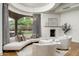 Sitting area by large windows with views of the outdoor space, and a modern fireplace at 8229 N Ridgeview Dr, Paradise Valley, AZ 85253