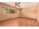 Spacious bedroom with wood-look floors and a large window letting in natural light at 8238 E Jackrabbit Rd, Scottsdale, AZ 85250