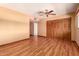 Bedroom with laminate flooring, a ceiling fan, and ample closet space at 8238 E Jackrabbit Rd, Scottsdale, AZ 85250