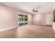 Bright living room featuring tile floors, access to the backyard, a ceiling fan, and neutral paint at 8238 E Jackrabbit Rd, Scottsdale, AZ 85250