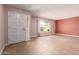 Spacious living room featuring neutral paint, tile floors, and a large window providing natural light at 8238 E Jackrabbit Rd, Scottsdale, AZ 85250