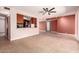 Bright open-concept living room flows into the kitchen and features tile floors and a ceiling fan at 8238 E Jackrabbit Rd, Scottsdale, AZ 85250