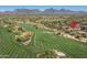 Picturesque aerial view of a golf course community surrounded by mountains and desert landscape at 8240 E Wingspan Way, Scottsdale, AZ 85255