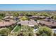 Overhead shot of estate home with a backyard pool, turf, and an expansive desert landscape at 8240 E Wingspan Way, Scottsdale, AZ 85255