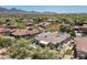 Drone shot of home displaying a manicured yard, outdoor living spaces, and desert surroundings at 8240 E Wingspan Way, Scottsdale, AZ 85255