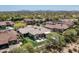 Expansive aerial view of a luxurious home with a pristine backyard, pool, and mountain views at 8240 E Wingspan Way, Scottsdale, AZ 85255