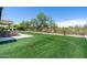 Well-maintained backyard with artificial turf, barbecue, and outdoor seating area at 8240 E Wingspan Way, Scottsdale, AZ 85255