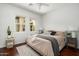 Bright bedroom featuring hardwood floors, ample natural light, and a cozy queen size bed at 8240 E Wingspan Way, Scottsdale, AZ 85255