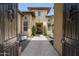 Private courtyard with travertine pavers, outdoor seating, and lush greenery near the front door at 8240 E Wingspan Way, Scottsdale, AZ 85255