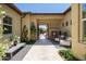 Inviting courtyard with an outdoor fireplace, cozy seating, travertine tile, and lush landscaping at 8240 E Wingspan Way, Scottsdale, AZ 85255