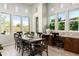 Bright dining room with large windows showcasing backyard views and custom built-in desk area at 8240 E Wingspan Way, Scottsdale, AZ 85255