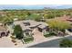 Breathtaking aerial view of home on a golf course lot with lush desert landscaping and a refreshing pool at 8240 E Wingspan Way, Scottsdale, AZ 85255