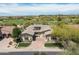 Stunning aerial view of a custom home on a golf course lot with beautiful desert landscaping at 8240 E Wingspan Way, Scottsdale, AZ 85255