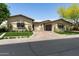 Beautiful home with manicured turf, stone accents, and a well-maintained circular driveway at 8240 E Wingspan Way, Scottsdale, AZ 85255