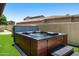Backyard hot tub with stairs to entry and landscaped surroundings at 8240 E Wingspan Way, Scottsdale, AZ 85255