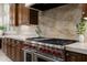 Close up of the gourmet kitchen featuring a stainless steel range with red knobs at 8240 E Wingspan Way, Scottsdale, AZ 85255