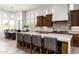 Gourmet kitchen with a large island, dark wood cabinets, and a stylish breakfast bar at 8240 E Wingspan Way, Scottsdale, AZ 85255