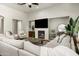Open-concept living room featuring a fireplace, large sectional sofa, and a cozy seating area at 8240 E Wingspan Way, Scottsdale, AZ 85255
