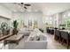 Bright and airy living room with a large sectional sofa, dining table, and open-concept design at 8240 E Wingspan Way, Scottsdale, AZ 85255