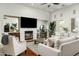 Comfortable living room showcasing a fireplace, bar area, large sofa, and natural lighting at 8240 E Wingspan Way, Scottsdale, AZ 85255