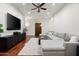 Spacious living room with recessed lighting, ceiling fan, hardwood floors, and comfortable sectional sofa at 8240 E Wingspan Way, Scottsdale, AZ 85255
