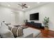 Inviting living room featuring hardwood floors, comfortable sectional, ceiling fan, and media center at 8240 E Wingspan Way, Scottsdale, AZ 85255