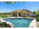 Inviting backyard pool with a tanning ledge, spa and covered patio with outdoor seating and manicured lawn at 8240 E Wingspan Way, Scottsdale, AZ 85255