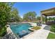 Backyard pool featuring a stone waterfall feature, Baja step and outdoor patio seating at 8240 E Wingspan Way, Scottsdale, AZ 85255