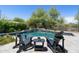 Backyard pool with waterfall feature, landscaping, and comfortable lounge chairs for outdoor relaxation at 8240 E Wingspan Way, Scottsdale, AZ 85255