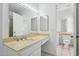 Bathroom with white cabinets, large mirror, and access to a standing shower at 8414 N Central Ave # B, Phoenix, AZ 85020